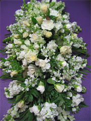 Casket Spray1 - This delicate casket spray of remembrance consists of white stock, white carnations, yellow anthirrhinums, lemon roses and fern<br><br>Code:554-5833-554-0000062479