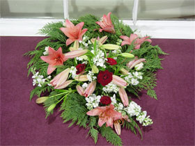 Wreath - A wreath of remembrance, made of pink asiatic lillies, white stock, red roses and cypress greenery<br><br>Code:554-1679-554-0000062475