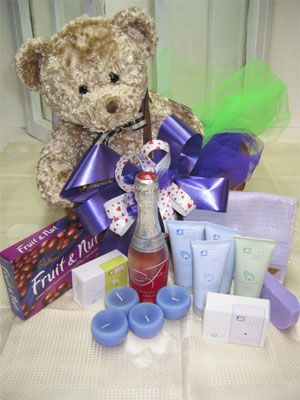 Basket ofTreats - Christopher Collection Bear (Marvin) 
Lindauer Fraise 750 ml 
Cadbury's Fruit and Nut Selection 240gm 
JC Lavender scented candles 
JC Bath Soap 130gm 
JC feet Tired Feet Relief Creme 70 ml 
JC Face Facial Nutrient Creme 70 ml 
JC Face Purifying Masque 70 ml 
J C Deep Pore Cleanser 70 ml 
Presented in bark covered willow basket 

All JC Products are made with organic ingredients, they soothe, rejuvenate, and hydrate. Suitable for all skin types, a must for a discerning gift buyer.<br><br>Code:554-9785-554-0000062448