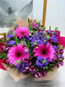 Pretty in Pink - Bright pink gerberas, purple double stock and pink alstromeria give a rich colour haze. Wrapped in a complementary colour and finished with a bow.<br><br>Code:554-6510-554-0000062446