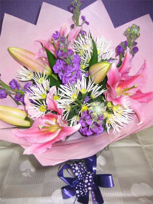 Pink Delight - Dainty pink oriental lillies in a nest of purple stock and spiky chrysanthemums.<br><br>Code:554-9688-554-0000062405
