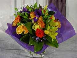 Royal Treatment - Make your Mum feel like a queen with this amazing mixture of yellow asiatic lillies, Iris, orange roses, agapanthus and greenery, wrapped in purple.<br><br>Code:554-8589-554-0000062401