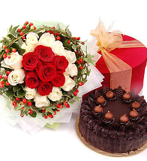 Double joy-Coddle Cake - What can be more enjoyable than having 2 delights- both flowers and cakes. It is simply divine. A rich tasty homemade Chocolate Cake 1.1kg and a bouquet of Sweet Roses to brighten her day. Options to use carnations in lieu of roses for posy.<br><br>Code:458-2067-458-0000109071